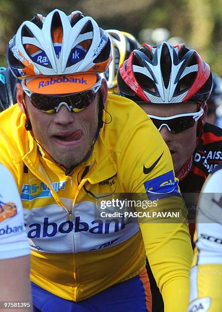 Third placed of the stage, Spanish cycling team Caisse d'Epargne's Spain's Luis Leon Sanchez rides with yellow jersey of overall leader, Netherland's...