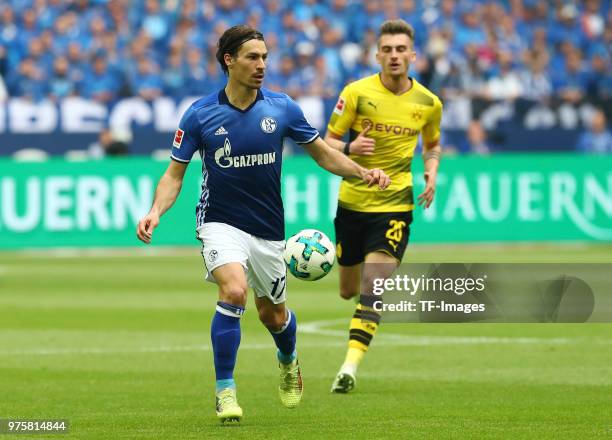 Benjamin Stambouli of Schalke and Maximilian Philipp of Dortmund battle for the ball during the Bundesliga match between FC Schalke 04 and Borussia...