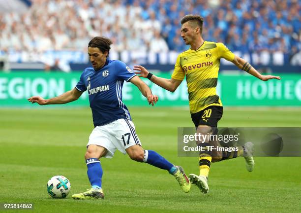 Benjamin Stambouli of Schalke and Maximilian Philipp of Dortmund battle for the ball during the Bundesliga match between FC Schalke 04 and Borussia...