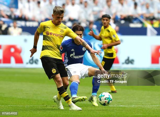 Maximilian Philipp of Dortmund and Benjamin Stambouli of Schalke battle for the ball during the Bundesliga match between FC Schalke 04 and Borussia...