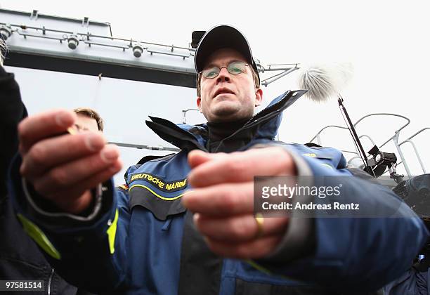 German Defense Minister Karl-Theodor zu Guttenberg looks on during his inaugural visit aboard the FGS Mecklenburg Vorpommern Navy frigate on March 9,...