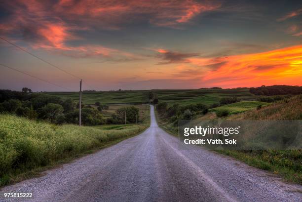 sunset over meadows, iowa, usa - country road stock pictures, royalty-free photos & images