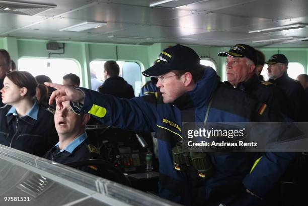 German Defense Minister Karl-Theodor zu Guttenberg points on during his inaugural visit aboard the FGS Mecklenburg Vorpommern Navy frigate on March...