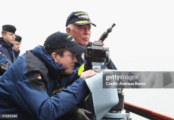 German Defense Minister Karl-Theodor zu Guttenberg looks through a telescope during his inaugural visit aboard the FGS Mecklenburg Vorpommern Navy...