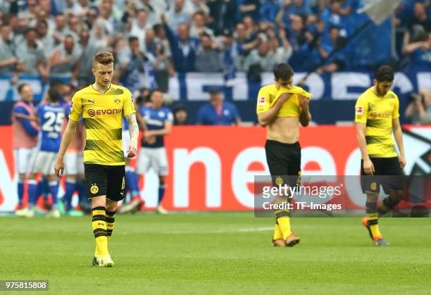 Marco Reus of Dortmund, Sokratis Papastathopoulos of Dortmund and Nuri Sahin of Dortmund look dejected during the Bundesliga match between FC Schalke...