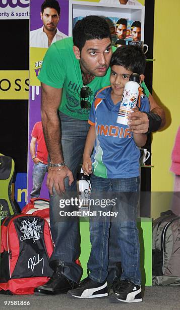 Yuvraj Singh with a fan during the launch of YUVI- his official merchandise line in Mumbai on March 7, 2010.