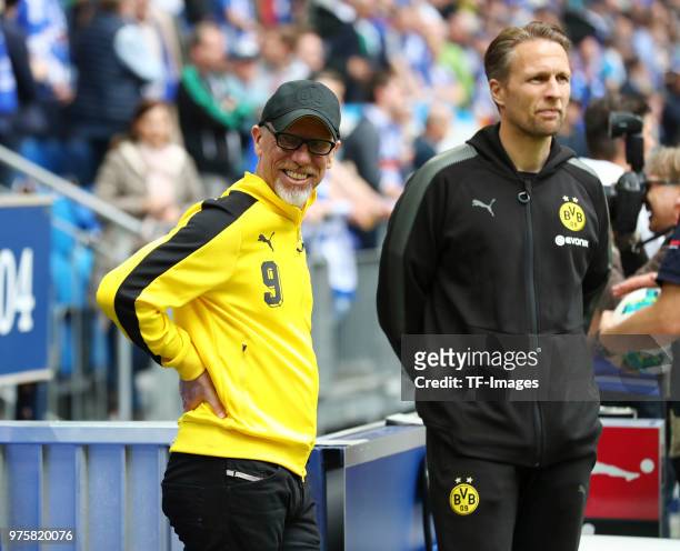 Head coach Peter Stoeger of Dortmund and Assistant coach Alexander Bade of Dortmund look on prior to the Bundesliga match between FC Schalke 04 and...