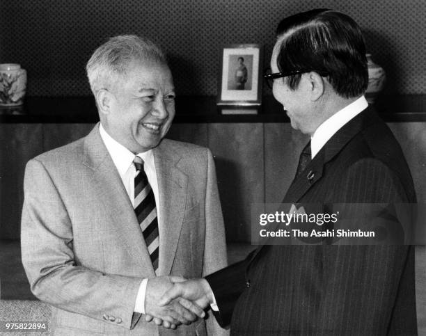 Prince Norodom Sihanouk Of Cambodia and Foreign Minister Sosuke Uno shake hands prior to their meeting at the Foreign Ministry on August 9, 1988 in...