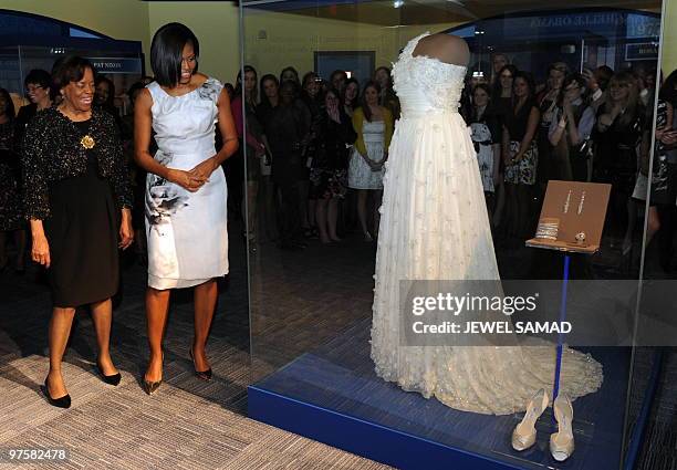 First Lady Michelle Obama , accompanied by her mother Marian Robinson, looks at a display of her 2009 inaugural gown, jewelries and shoes after a...
