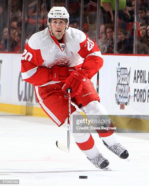 Drew Miller of the Detroit Red Wings skates up ice with the puck during an NHL game against the Nashville Predators at Joe Louis Arena on March 5,...