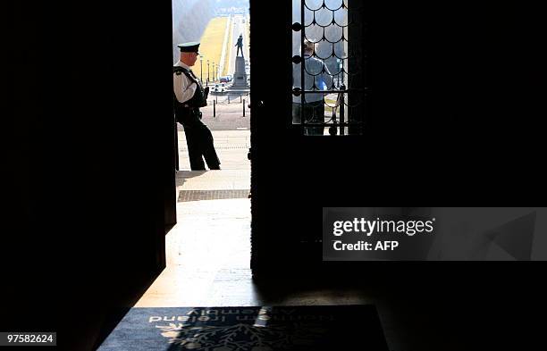 Policeman waits outside the doors at Stormont Parliament buildings in Belfast, Northern Ireland, on March 9, 2010. Northern Ireland's lawmakers...