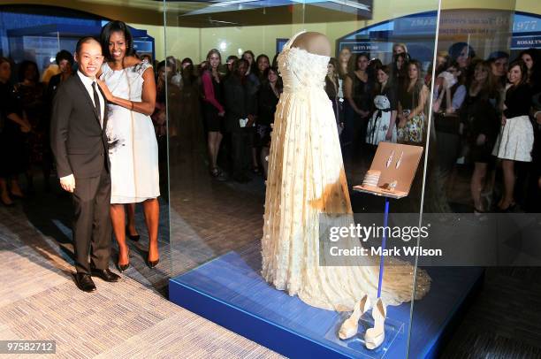 First lady Michelle Obama stands with inaugural dress designer Jason Wu in front of the inaugural gown she wore to the inaugural balls and is now on...