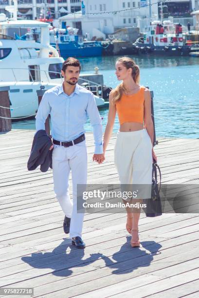 beautiful young couple walking at the city port - destination fashion 2016 stock pictures, royalty-free photos & images