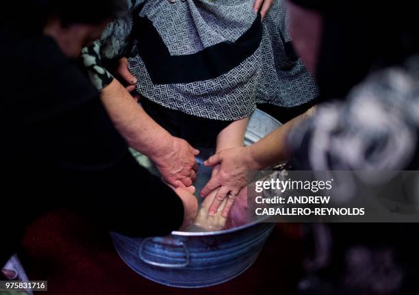 Worshiper has her feet washed during a Pentecostal serpent handlers service at the House of the Lord Jesus church in Squire, West Virginia on May 27,...