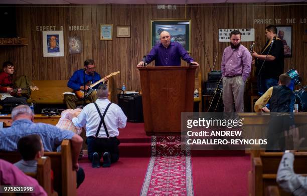 Pastor Chris Wolford takes a break and looks over his congregation during a Pentecostal serpent handlers service at the House of the Lord Jesus...