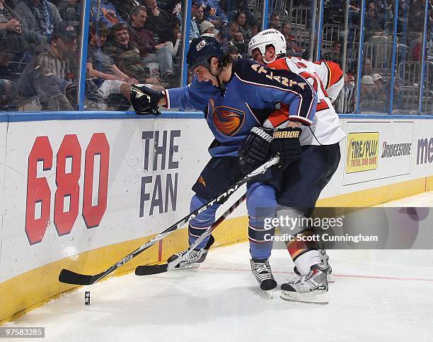 Chris Thorburn of the Atlanta Thrashers battles for the puck against Bryan McCabe of the Florida Panthers at Philips Arena on March 2, 2010 in...