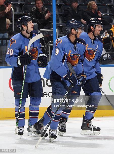 Colby Armstrong of the Atlanta Thrashers celebrates with Evander Kane and Ron Hainsey after scoring against the Florida Panthers at Philips Arena on...