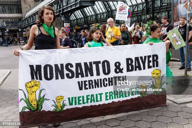 May 2018, Germany, Hamburg: Protestors carry a banner reading 'Monsanto & Bayer vernichten. Vielfalt erhalten' at the front of the protest march...