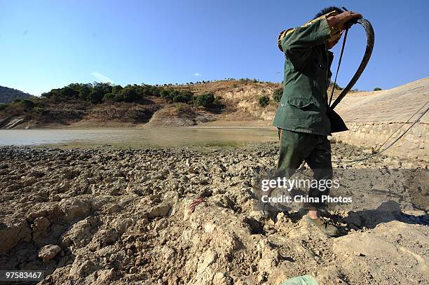 Resident fetches water from a drying reservoir on March 8, 2010 in Panzhihua of Sichuan Province, China. There was no rainfall in nearly half year in...