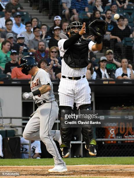 Nicholas Castellanos of the Detroit Tigers scores as Omar Narvaez of the Chicago White Sox takes a late throw during the third inning on June 15,...
