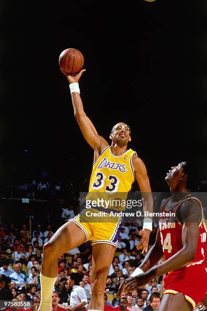 Kareem Abdul-Jabbar of the Los Angeles Lakers shoots a hook shot against Hakeem Olajuwon of the Houston Rockets during a game played in 1988 at the...