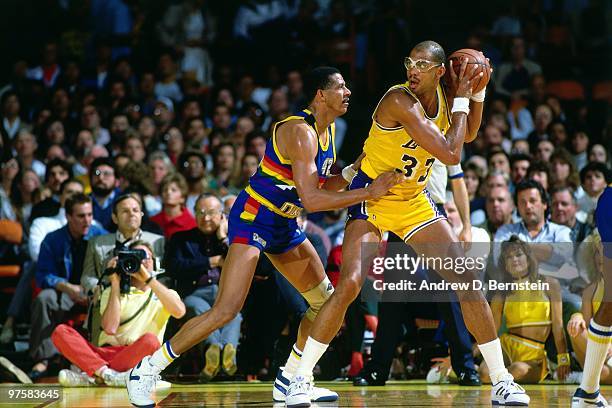 Kareem Abdul-Jabbar of the Los Angeles Lakers posts up against Wayne Cooper of the Denver Nuggets during a game played in 1986 at the Great Western...