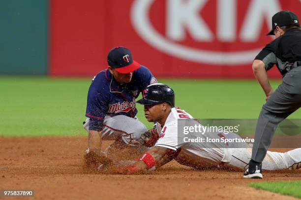 Cleveland Indians third baseman Jose Ramirez is tagged out at second base by Minnesota Twins infielder Ehire Adrianza trying to stretch a single into...