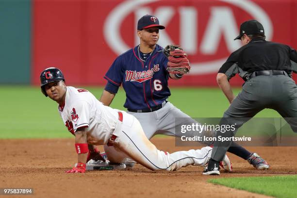 Cleveland Indians third baseman Jose Ramirez is tagged out at second base by Minnesota Twins infielder Ehire Adrianza trying to stretch a single into...