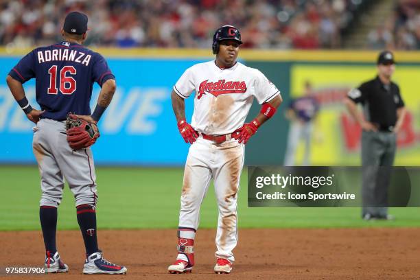 Minnesota Twins infielder Ehire Adrianza and Cleveland Indians third baseman Jose Ramirez wait as a call at second base is reviewed by video replay...