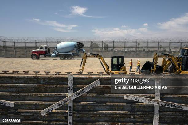 Wooden crosses honoring migrants who died attempting to cross into the US hang at the US/Mexico border in Tijuana, Baja California state, Mexico, as...