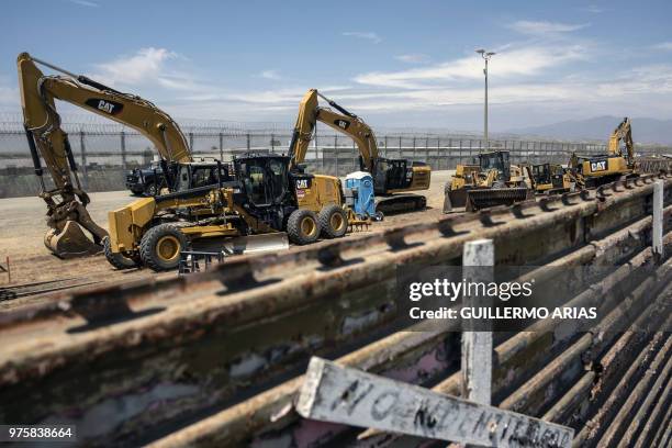 Construction works are carried out to replace a section of the old Mexico/US border fence at Mesa de Otay, San Diego, California, US, as seen from...