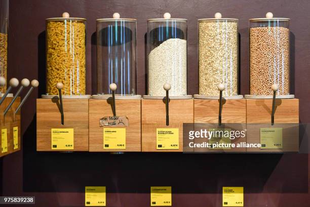 May 2018, Germany, Berlin: Noodles, cornflakes, oats and chickpeas are offered in dispensers at the zero waste shop 'Der Sache wegen - einfach...