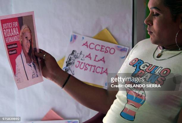 Member of the Pink Unity Collective holds a poster demanding justice in the death of Honduran transgender woman Roxana Hernandez, in San Pedro Sula,...