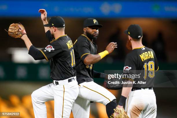 Gregory Polanco of the Pittsburgh Pirates celebrates with Jordy Mercer of the Pittsburgh Pirates and Colin Moran of the Pittsburgh Pirates after...