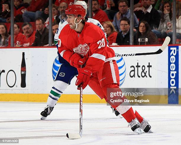 Drew Miller of the Detroit Red Wings skates with the puck during an NHL game against the Vancouver Canucks at Joe Louis Arena on March 3, 2010 in...