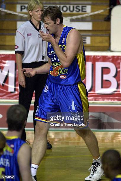 Paul Rees for Adelaide holds a hand to his bloodied mouth after colliding with Jason Smith for Victoria in the match between the Adelaide 36ers and...