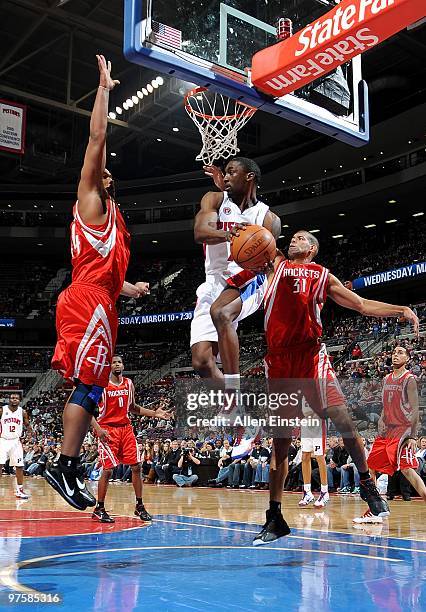 Ben Gordon of the Detroit Pistons goes to the basket against Chuck Hayes and Shane Battier of the Houston Rockets during the game on March 7, 2010 at...