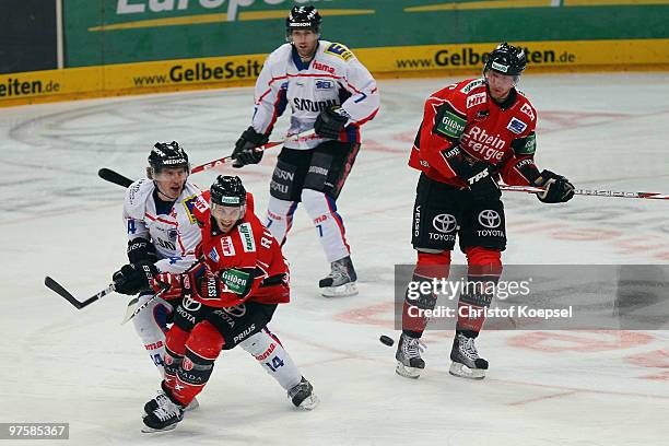 Tim Hambly of Ingolstadt tackles Daniel Rudslaett of Koelner Haie during the DEL match between Koelner Haie and ERC Ingolstadt at the Lanxess Arena...