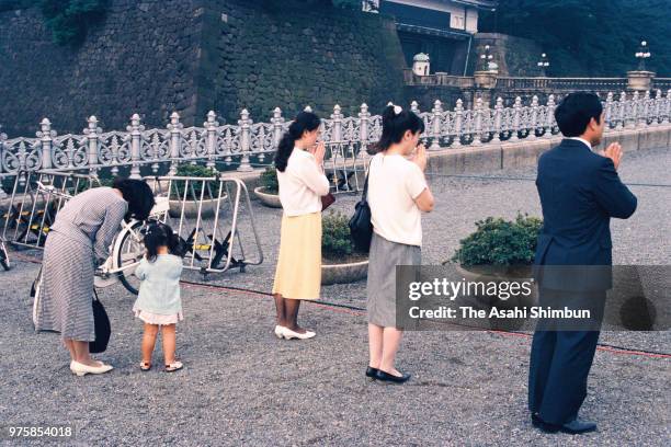 Well-wishers pray for Emperor Hirohito in front of the Imperial Palace after vomiting blood on September 21, 1988 in Tokyo, Japan.