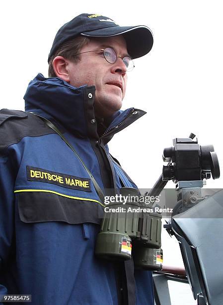 German Defense Minister Karl-Theodor zu Guttenberg looks on during his inaugural visit aboard the FGS Mecklenburg Vorpommern Navy frigate on March 9,...