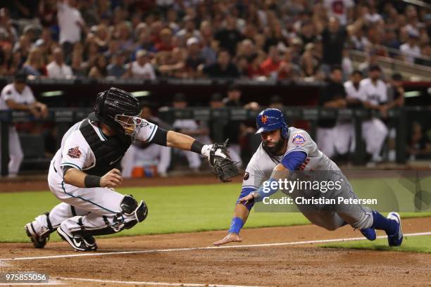 Jose Bautista of the New York Mets is tagged out by catcher Alex Avila of the Arizona Diamondbacks attempting to score a run during the second inning...