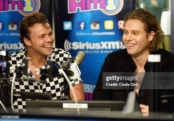 Ashton Irwin and Luke Hemmings of 5 Seconds of Summer visit SiriusXM's Morning Mash Up SiriusXM Studios on June 15, 2018 in New York City.