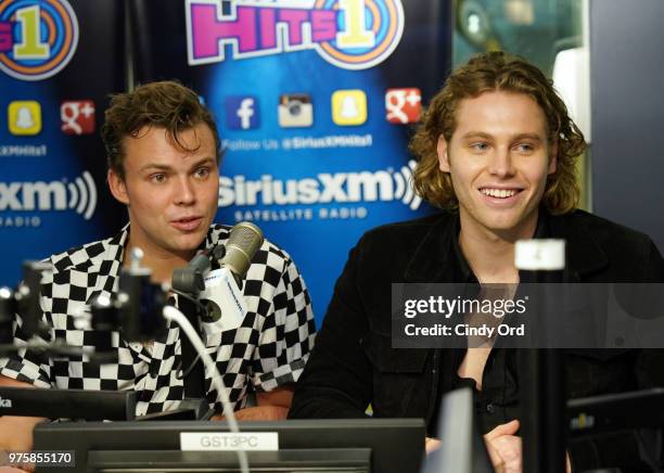 Ashton Irwin and Luke Hemmings of 5 Seconds of Summer visit SiriusXM's Morning Mash Up SiriusXM Studios on June 15, 2018 in New York City.