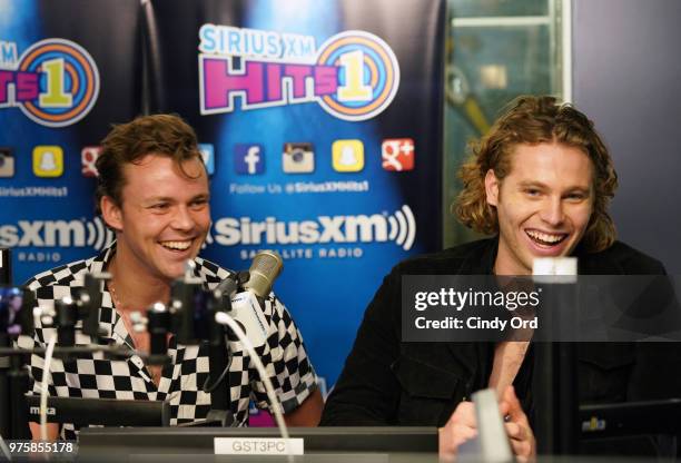 Ashton Irwin and Luke Hemmings of 5 Seconds of Summer visit SiriusXM's Morning Mash Up SiriusXM Studios on June 15, 2018 in New York City.