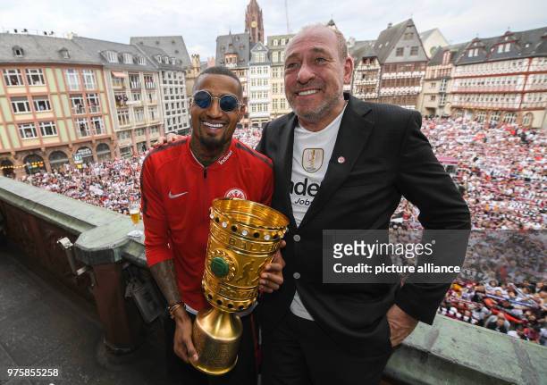 May 2018, Germany, Frankfurt am Main: Eintracht Frankfurt's Kevin-Prince Boateng and Peter Fischer, president of Eintracht Frankfurt, hold the cup...