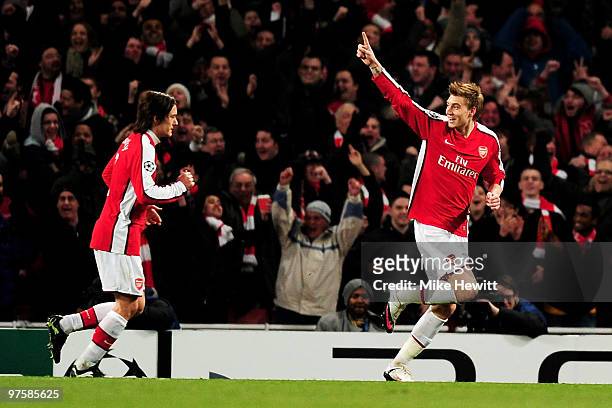 Nicklas Bendtner of Arsenal celebrates with teammate Tomas Rosicky after scoring his team's second goal during the UEFA Champions League round of 16...