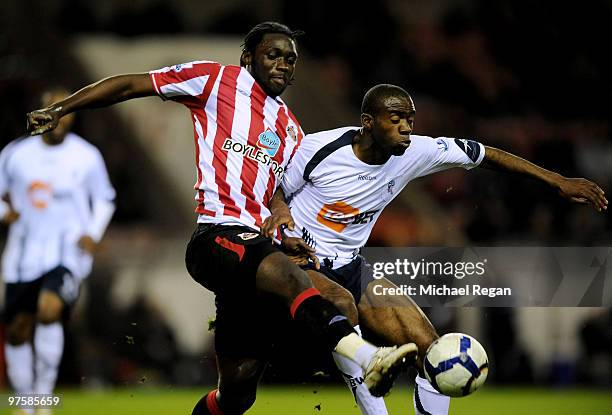 Kenwyne Jones of Sunderland challenges Fabrice Muamba of Bolton during the Barclays Premier League match between Sunderland and Bolton Wanderers at...