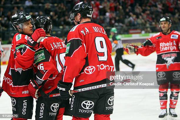 Marcel Mueller of Koelner Haie celebrates the first goal with team mates Moritz Mueller and Jason Jaspers during the DEL match between Koelner Haie...