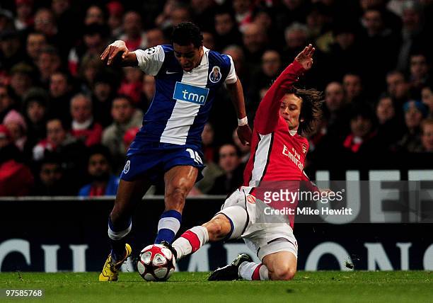 Alvaro Pereira of Porto is tackled by Tomas Rosicky of Arsenal during the UEFA Champions League round of 16 match between Arsenal and FC Porto at the...