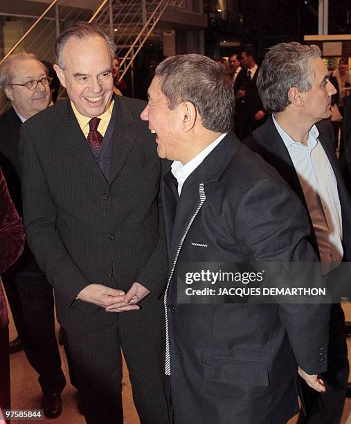 Japanese film director and artist Takeshi Kitano talks with French culture minister Frederic Mitterrand during a visit of his exhibition and after...